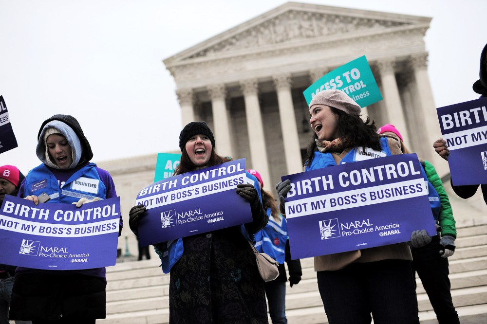 Demonstrators rally while the Supreme Court hears arguments on aspects of the Affordable Care Act involving a mandate for contraception, March 25, 2014.