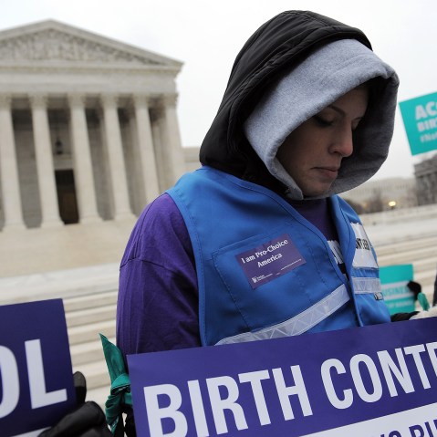 Alena Yarmosky holds a sign outside the Supreme Court of the United States on March 25, 2014 in Washington, DC.