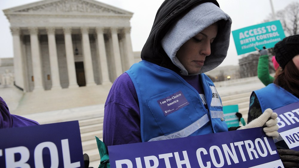 Alena Yarmosky holds a sign outside the Supreme Court of the United States on March 25, 2014 in Washington, DC.