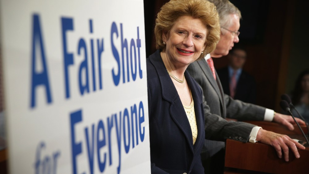 Sen. Debbie Stabenow (D-MI) looks at a poster during a news conference March 26, 2014 on Capitol Hill in Washington, D.C.