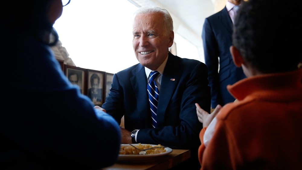 U.S. Vice President Joe Biden sits with customers while visiting a restaurant on March 26, 2014 in Washington, DC.