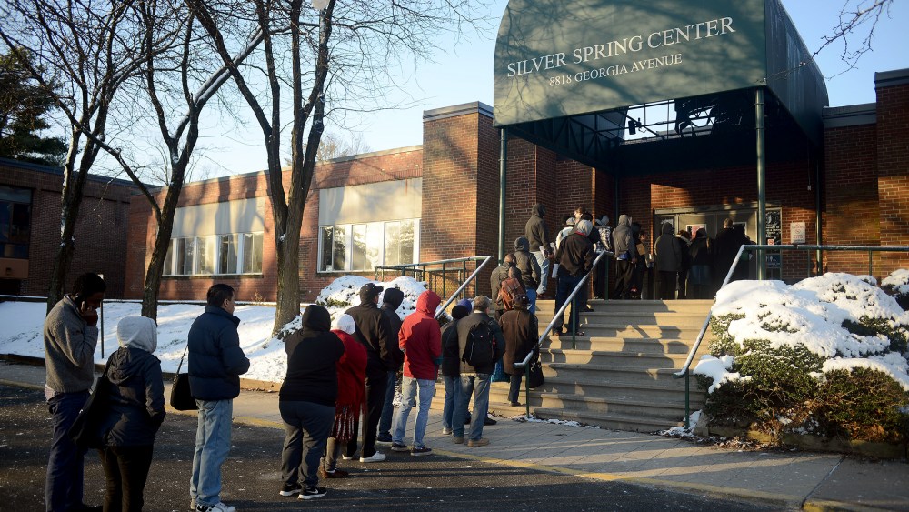 Dozens of uninsured residents of Montgomery County stand in line at the Department of Health and Human Services of the Silver Spring Center to sign up for insurance on March 26, 2014.