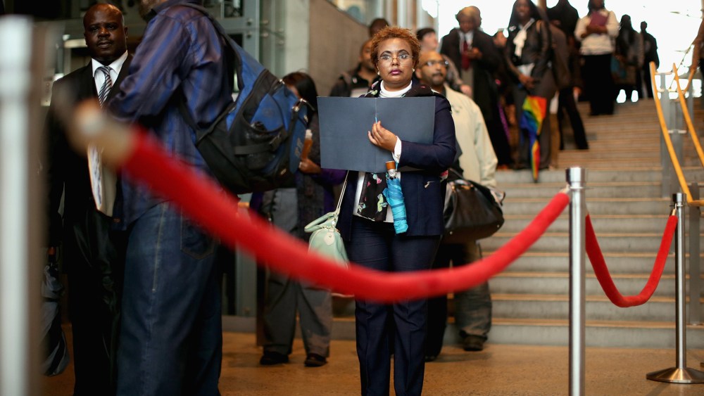 Almaz Mekonnen (C) stands in line with some of the 1,500 people seeking employment during a job fair in Washington, DC. Mar. 28, 2014.