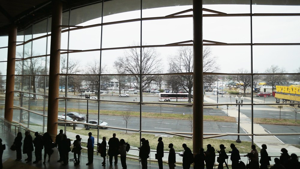 About 1,500 people seeking employment wait in line to enter a job fair at the Arena Stage at the Mead Center for American Theater, March 28, 2014 in Washington, D.C.