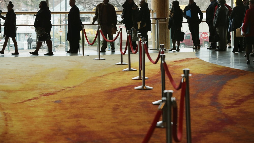 About 1,500 people seeking employment wait in line to enter a job fair in Washington, DC., Mar. 28, 2014.