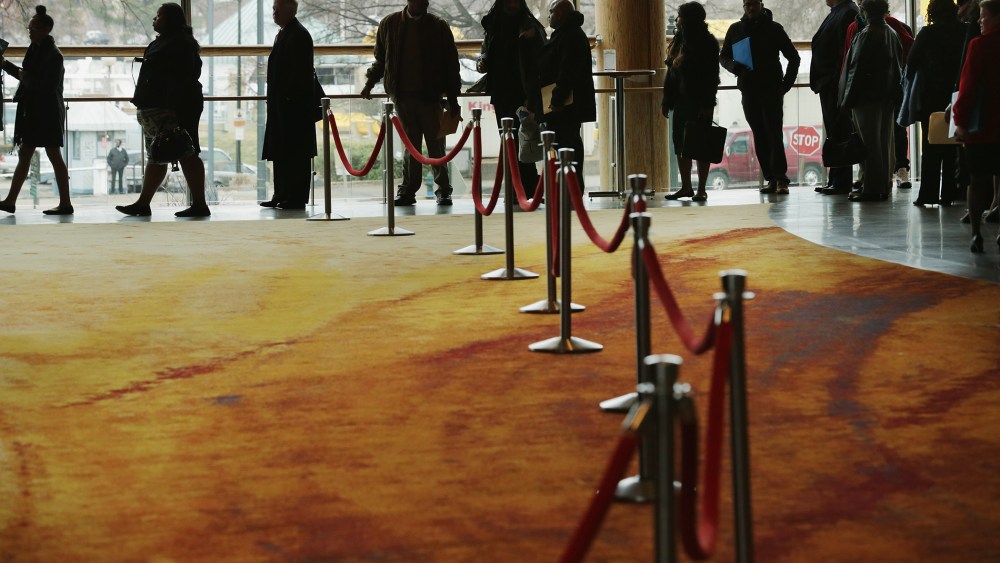 About 1,500 people seeking employment wait in line to enter a job fair, March 28, 2014 in Washington, D.C.
