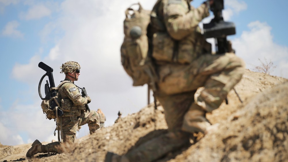 Sgt. Nathan Harrell with the U.S. Army's 2nd Battalion 87th Infantry Regiment, 3rd Brigade Combat Team, 10th Mountain Division, patrols on the edge of a village near Pul-e Alam, Afghanistan on March 29, 2014. (Photo by Scott Olson/Getty)