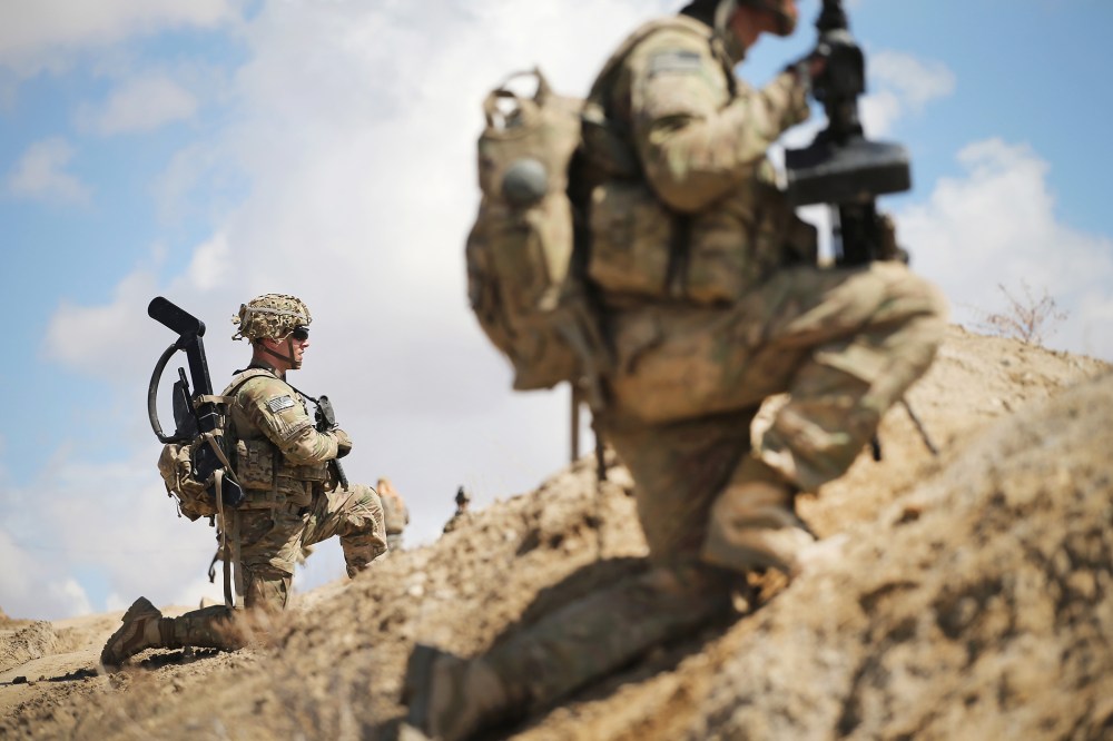 Sgt. Nathan Harrell with the U.S. Army's 2nd Battalion 87th Infantry Regiment, 3rd Brigade Combat Team, 10th Mountain Division, patrols on the edge of a village near Pul-e Alam, Afghanistan on March 29, 2014. (Photo by Scott Olson/Getty)
