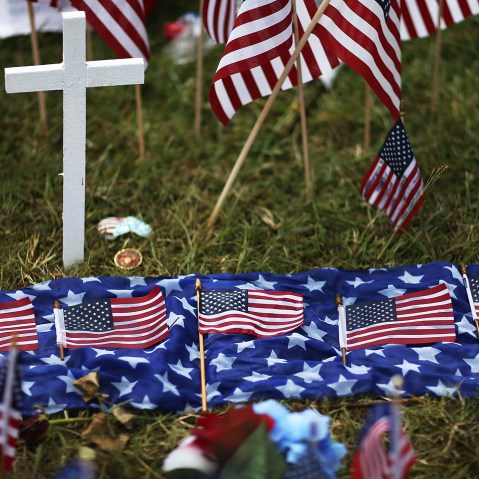 Five American flags in honor of the five killed are seen lain out in the memorial near the Armed Forces Career Center/National Guard Recruitment Office which had been shot up on July 19, 2015 in Chattanooga, Tenn. (Photo by Joe Raedle/Getty)