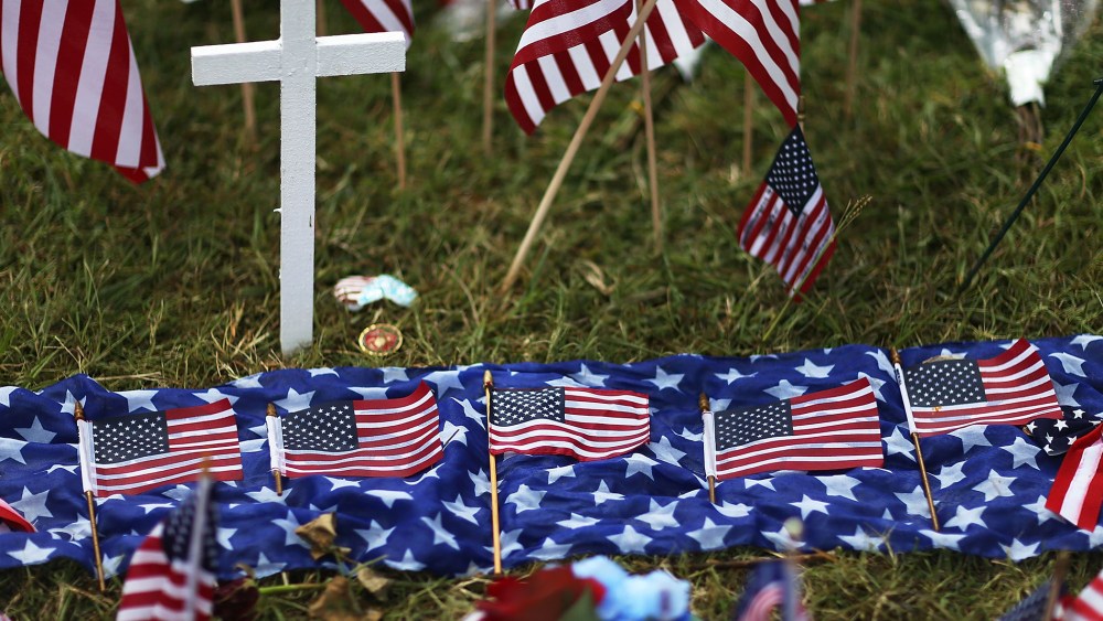 Five American flags in honor of the five killed are seen lain out in the memorial near the Armed Forces Career Center/National Guard Recruitment Office which had been shot up on July 19, 2015 in Chattanooga, Tenn. (Photo by Joe Raedle/Getty)