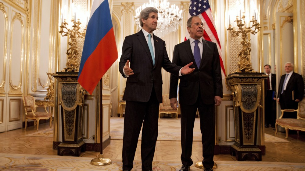 US Secretary of State John Kerry (L) gestures next to Russian Foreign Minister Sergey Lavrov (R) at the Russian Ambassador's Residence in Paris, March 30, 2014.