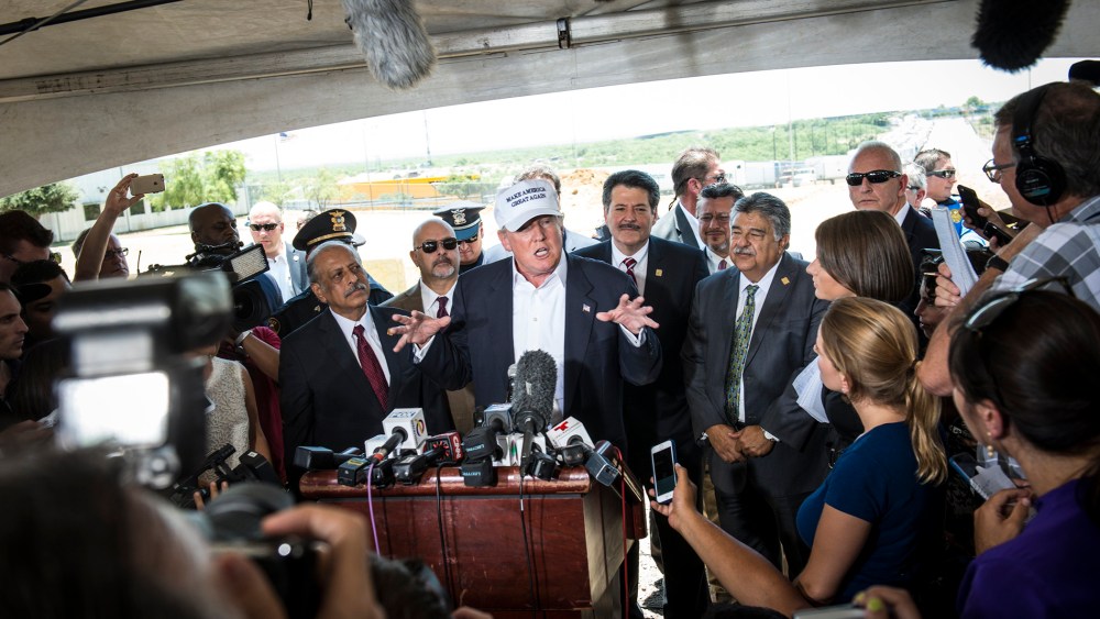 Republican Presidential candidate and business mogul Donald Trump talks to the media along the U.S. Mexico border during his trip to the border on July 23, 2015 in Laredo, Texas. (Photo by Matthew Busch/Getty)