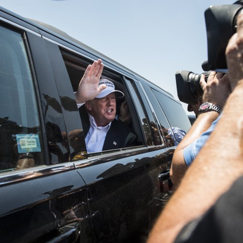 Republican Presidential candidate and business mogul Donald Trump talks to media from his car wearing a, "Make America Great Again," hat during his trip to the border on July 23, 2015 in Laredo, Texas. (Photo by Matthew Busch/Getty)