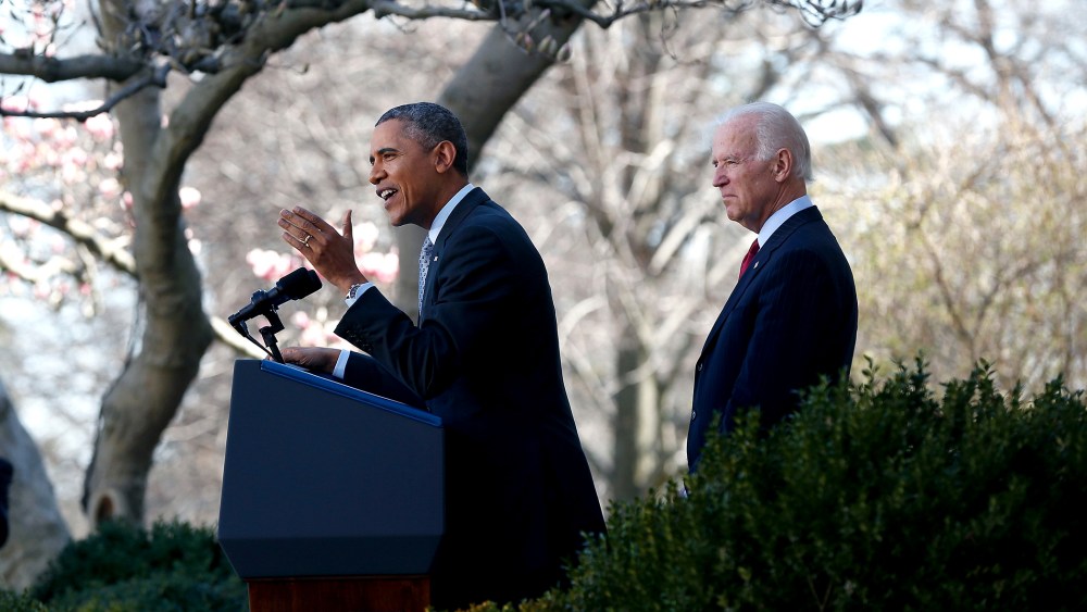 U.S. President Barack Obama (C) speaks about the Affordable Care Act as U.S. Vice President Joe Biden (R) watches in the Rose Garden of the White House on April 1, 2014 in Washington, DC.