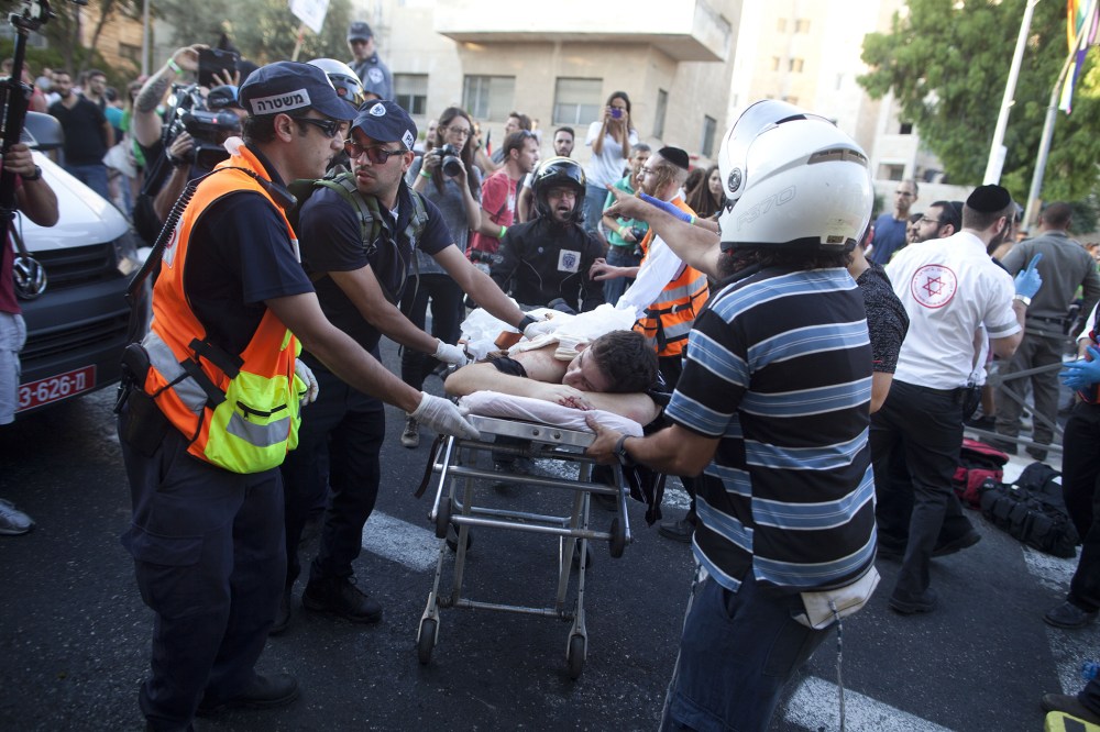 An wounded an Israeli man receives treatment during the Gay Pride Parade on July 30, 2015 in Jerusalem, Israel. (Photo by Lior Mizrahi/Getty)