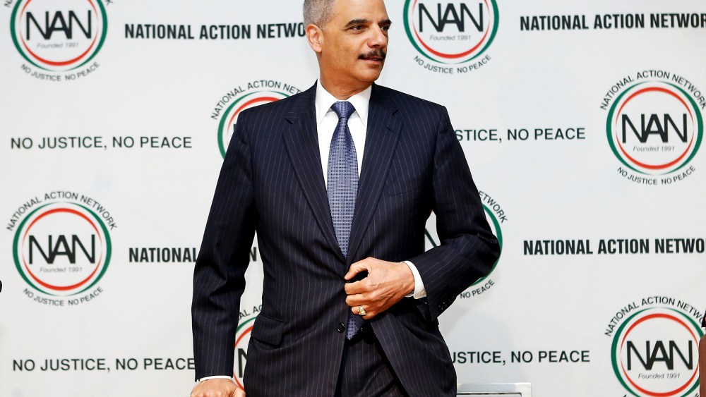 U.S. Attorney General Eric Holder takes a seat at the 16th Annual National Action Network's Convention in New York, April 9, 2014.