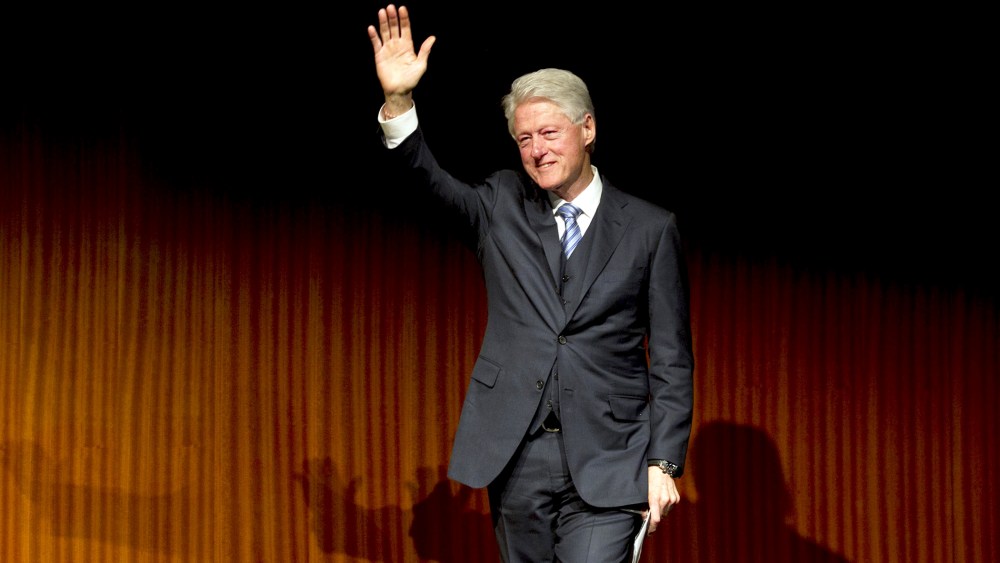Former President Bill Clinton waves after giving a speech during the Civil Rights Summit at the LBJ Presidential Library, April 9, 2014 in Austin, Texas.
