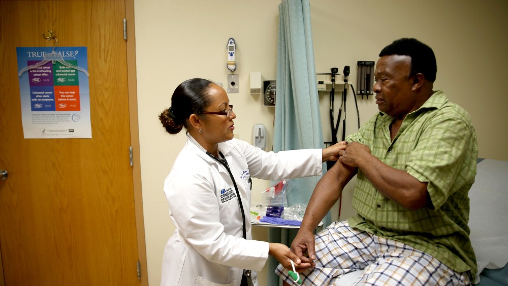 Felue Chang, who is newly insured through the Affordable Care Act, receives a checkup, April 15, 2014 in Hollywood, Florida.