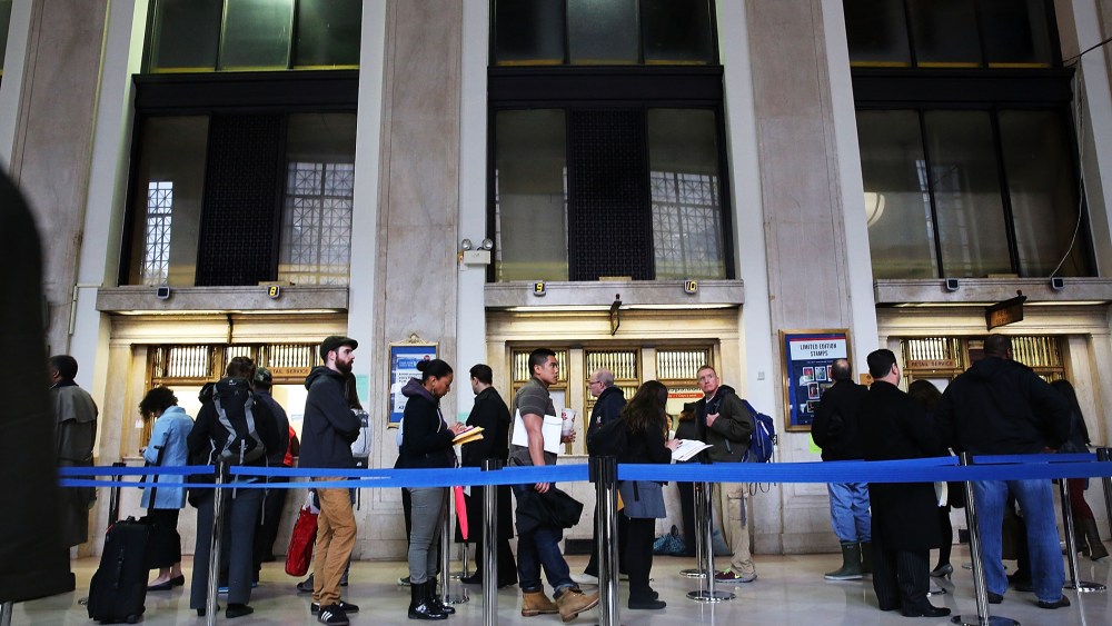 People wait in line in the James A. Farley post office in Manhattan, which is staying open until midnight on that last day to file taxes on April 15, 2014 in New York, N.Y. (Photo by Spencer Platt/Getty)