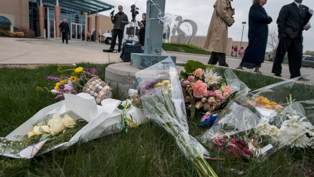 Crowds pass by a makeshift memorial following an interfaith service April 17, 2014 honoring victims of the shootings in Overland Park, Kansas.