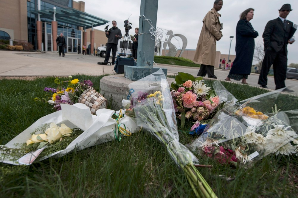 Crowds pass by a makeshift memorial following an interfaith service April 17, 2014 honoring victims of the shootings in Overland Park, Kansas.