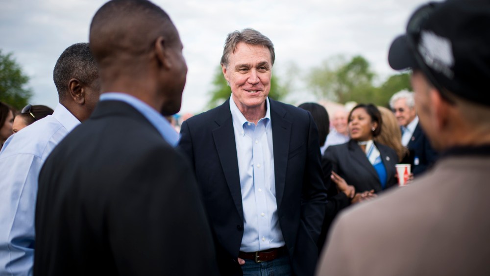 Candidate for U.S. Senate David Perdue speaks with attendees at a Law Enforcement Cookout in Glennville, Ga., on Thursday, April 17, 2014.