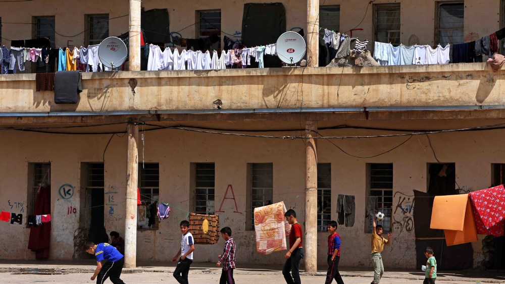 Young refugees are pictured in a make-shift camp in the Kurdish town of Akra in Iraq's Mosul region, north of Baghdad, on April 19, 2014.