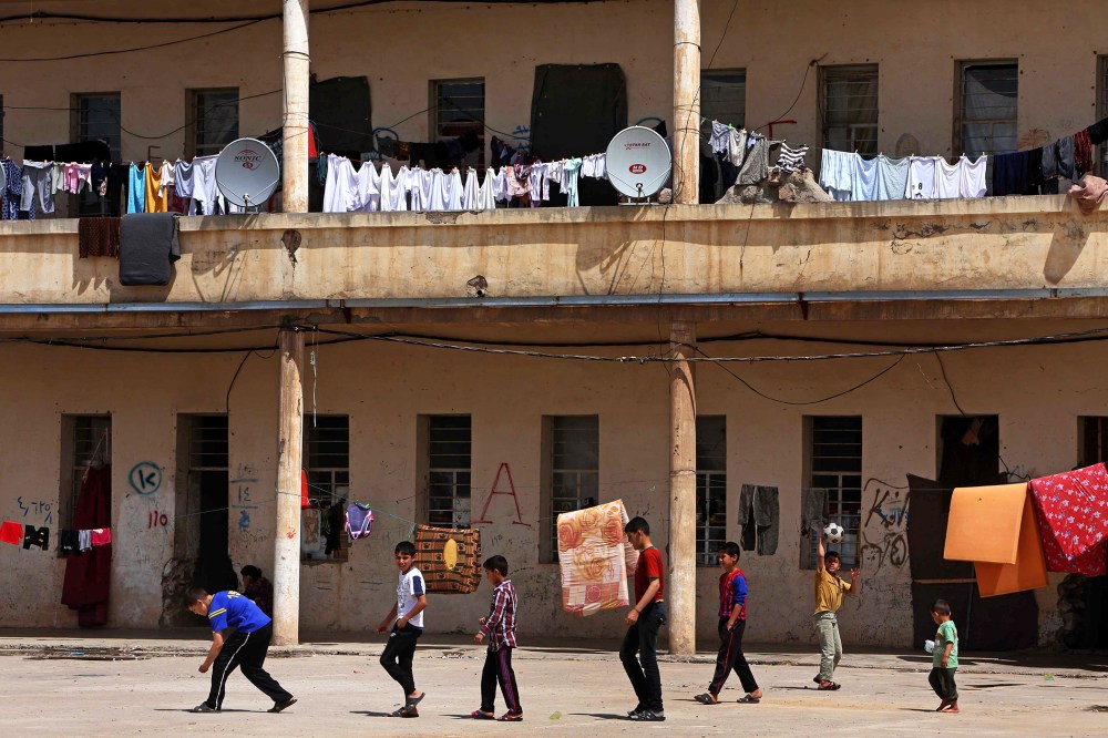 Young refugees are pictured in a make-shift camp in the Kurdish town of Akra in Iraq's Mosul region, north of Baghdad, on April 19, 2014.