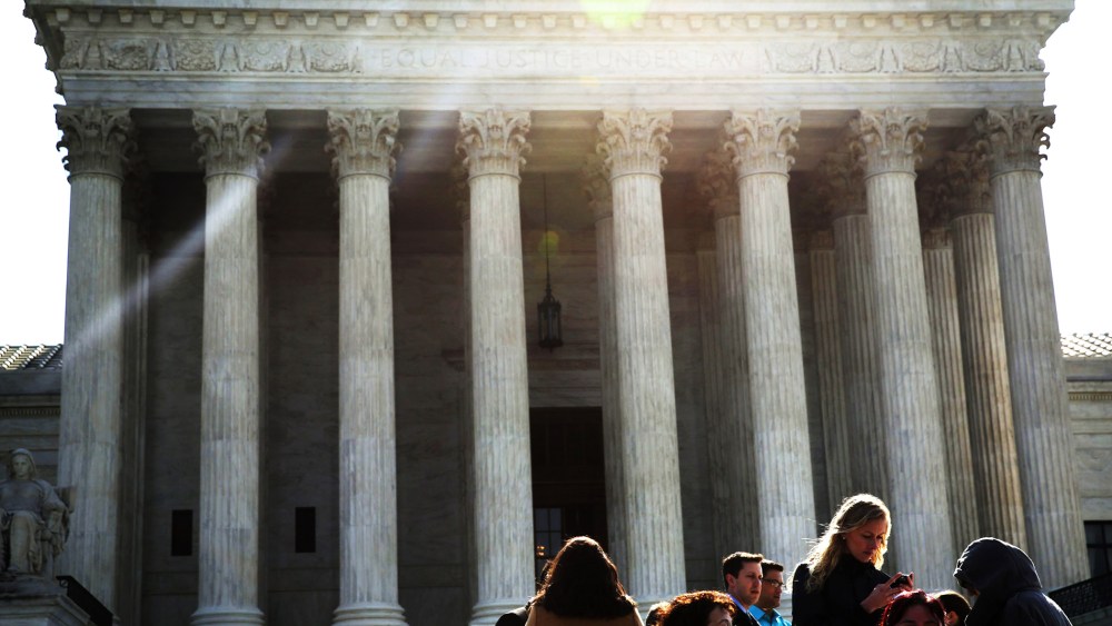 People wait in-line to enter the U.S. Supreme Court to hear oral arguments April 22, 2014 in Washington, DC.