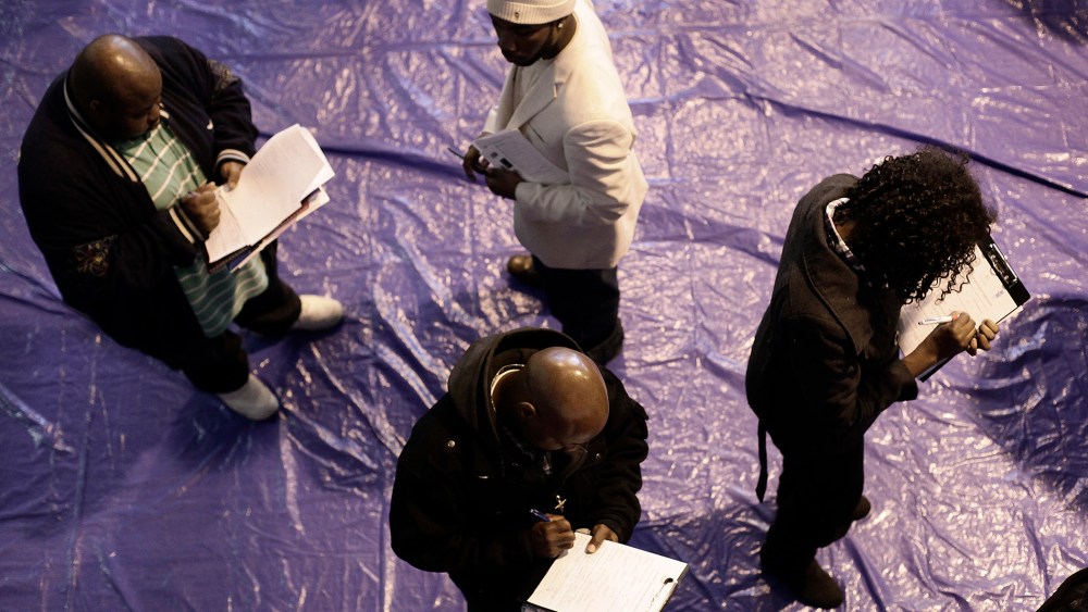 People seeking employment fill out applications at a job fair at the Matrix Center April 23, 2014 in Detroit, Michigan.