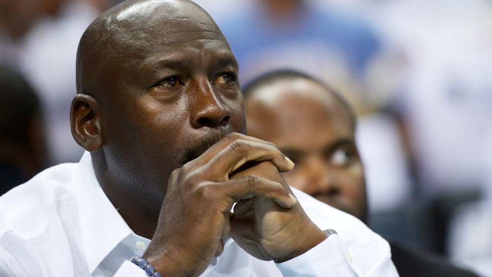Michael Jordan watches as the Charlotte Bobcats play the Miami Heat, April 26, 2014 in Charlotte, North Carolina.