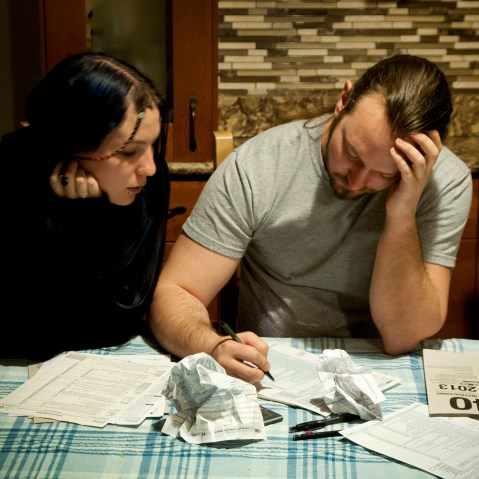 A couple does their taxes, April 13, 2014. (Photo by Patrick Colvin/Getty)
