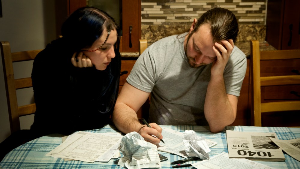 A couple does their taxes, April 13, 2014. (Photo by Patrick Colvin/Getty)