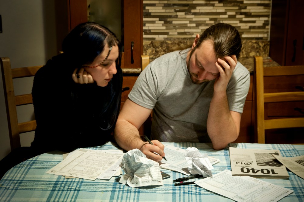 A couple does their taxes, April 13, 2014. (Photo by Patrick Colvin/Getty)