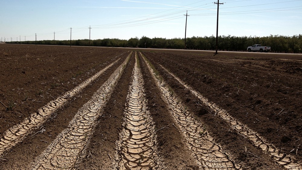 Dried and cracked earth on an unplanted field at a farm on April 29, 2014 near Mendota, California.