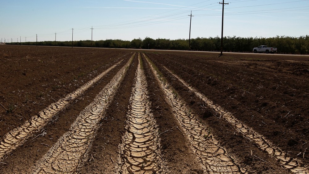 Dried and cracked earth is visible on an unplanted field at a farm on April 29, 2014 near Mendota, California.