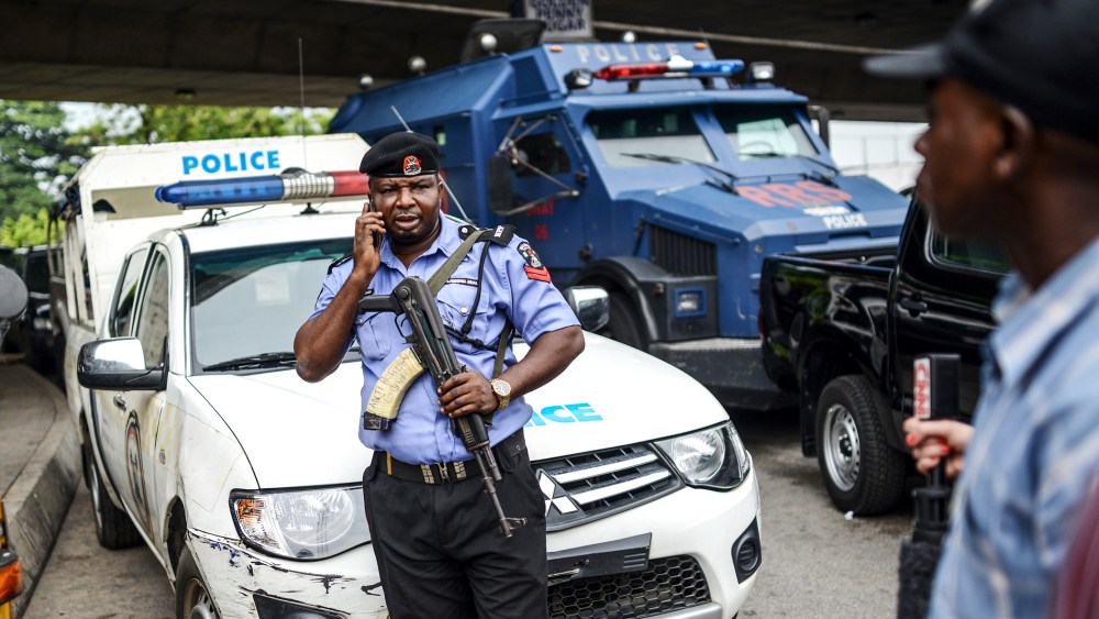 Nigerian security forces stand guard as demonstrators march during a rally to demand the government rescue schoolgirls abducted by suspected Boko Haram militants two weeks ago, in Lagos, Nigeria, May 01, 2014.