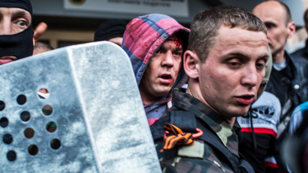 Pro-Russian protesters detain a man who was beaten and accused of being a provocateur outside the Executive Council building on May 4, 2014 in Donetsk, Ukraine.