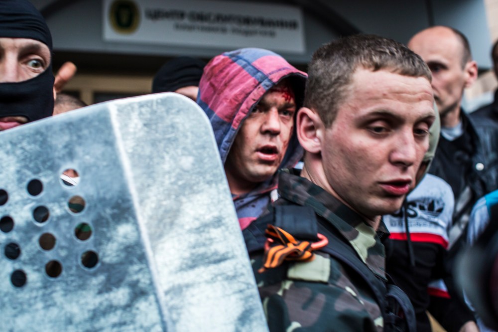 Pro-Russian protesters detain a man who was beaten and accused of being a provocateur outside the Executive Council building on May 4, 2014 in Donetsk, Ukraine.