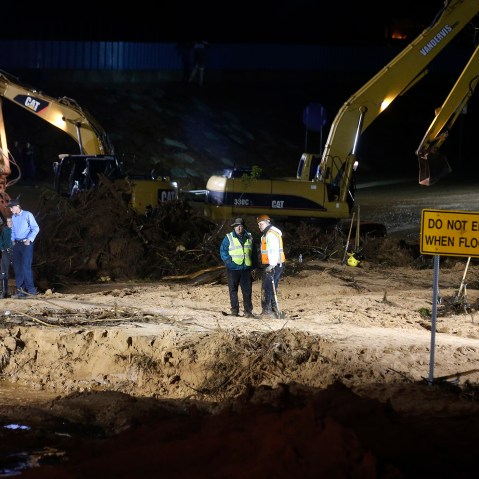 Rescuers use large construction equipment to remove flood debris from Short Creek as it crosses Central Street on Sept. 15, 2015 in Hildale, Utah. (Photo by George Frey/Getty)