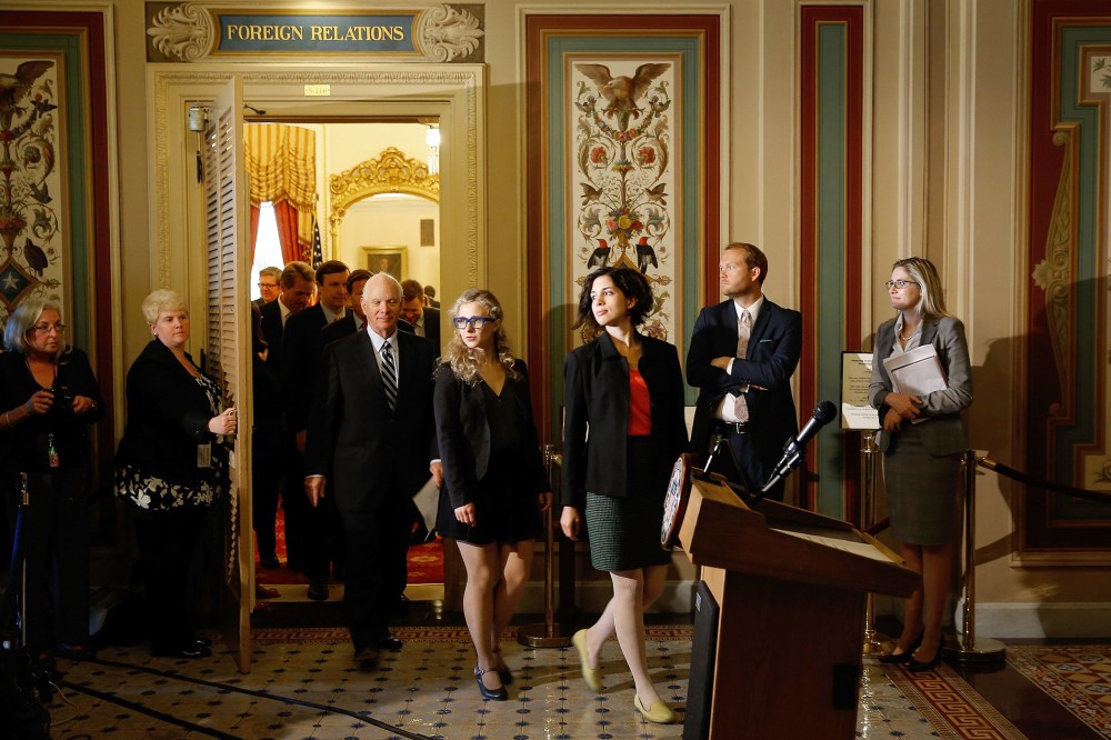 Nadya Tolokonnikova (R) and Maria Alyokhina (C), members of the Russian punk protest group Pussy Riot, leave the Senate Foreign Relations Committee room at the U.S. Capitol on May 6, 2014