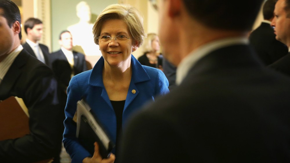 U.S. Sen. Elizabeth Warren (D-MA) (C) walks towards the Senate Chamber after a policy luncheon May 6, 2014 on Capitol Hill in Washington, DC.