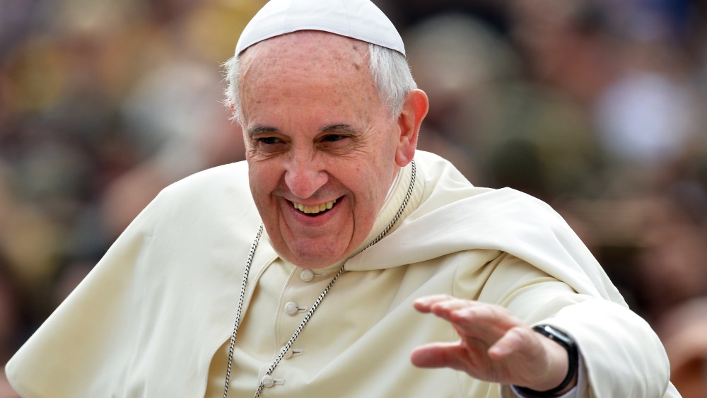 Pope Francis waves to the crowd as he arrives to hold his general audience at St Peter's square, on May 7, 2014 in Vatican city.
