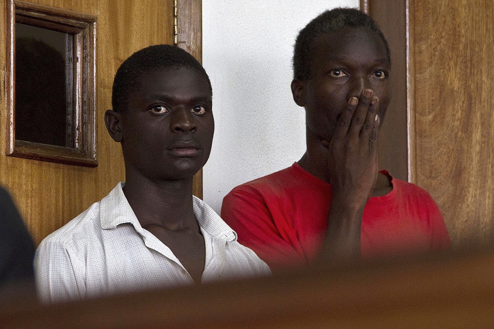 Two Ugandan men, Kim Mukisa (R) and Jackson Mukasa (L) appear before the Uganda Chief Magistrates Court in Kampala on May 7, 2014.