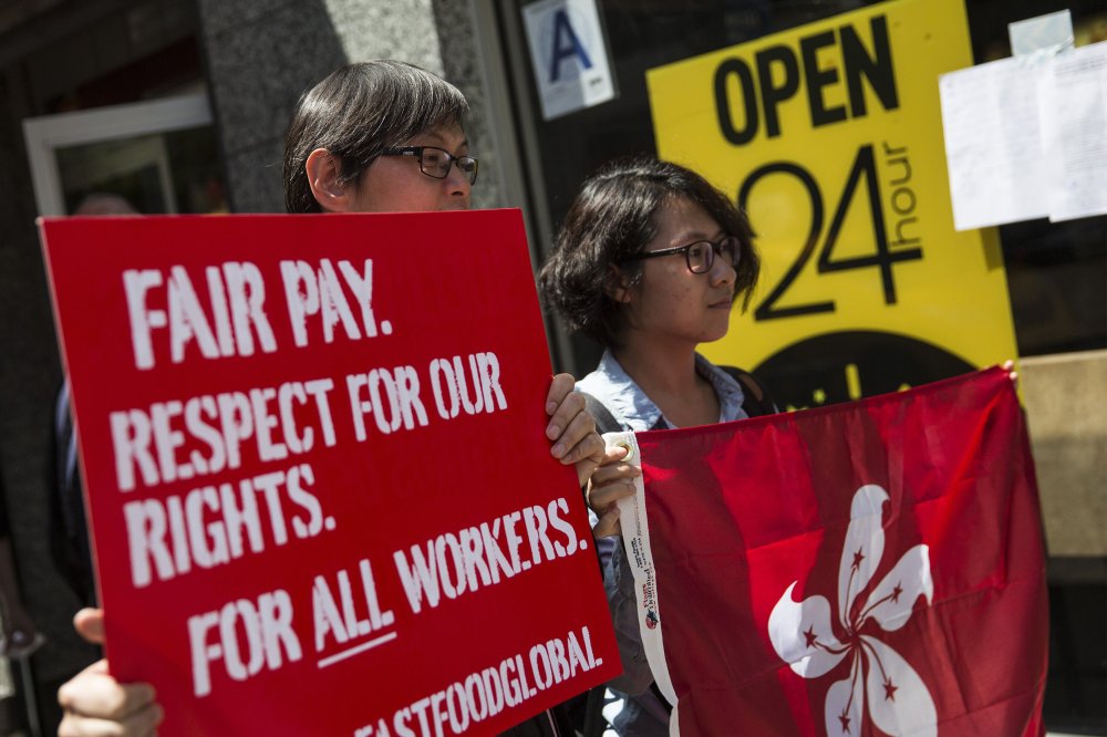 Protesters lobby for higher wages for fast food workers and urge fast food workers from around the globe to join their campaign outside a McDonalds on May 7, 2014 in New York City.