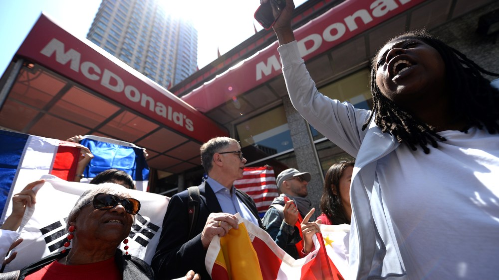 Fast-food workers from around the world stage a protest in front of a McDonald's restaurant, campaigning for higher pay, in New York on May 7, 2014