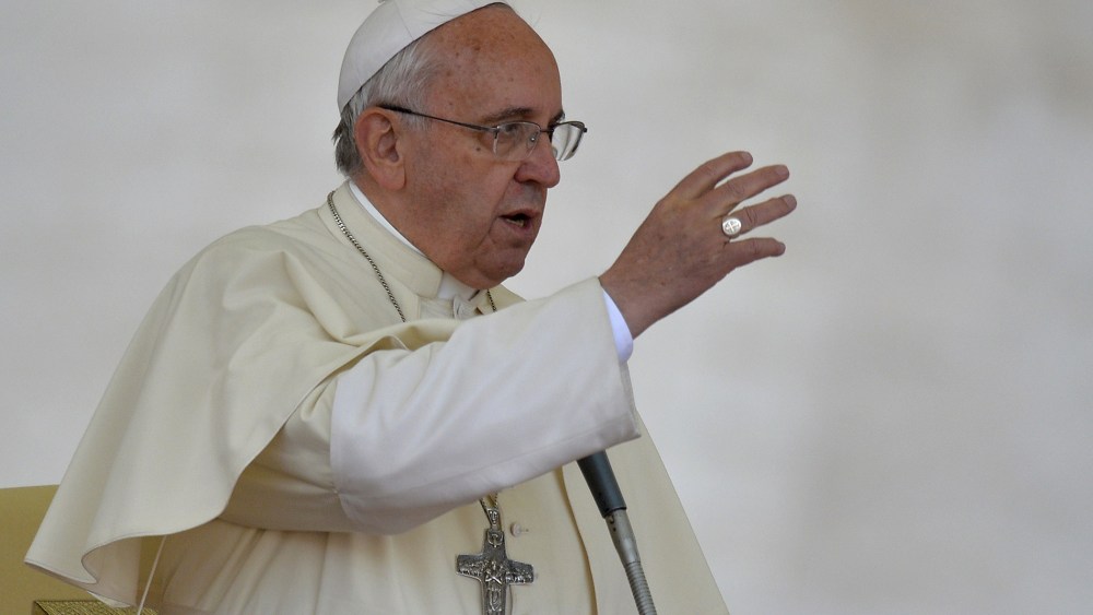 Pope Francis gives the benediction at the end of an audience with Catholic schools at St Peter's square on May 10, 2014 at the Vatican.
