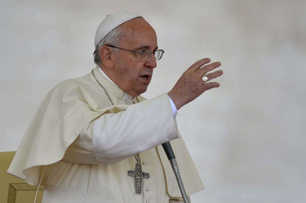 Pope Francis gives the benediction at the end of an audience with Catholic schools at St Peter's square on May 10, 2014 at the Vatican.
