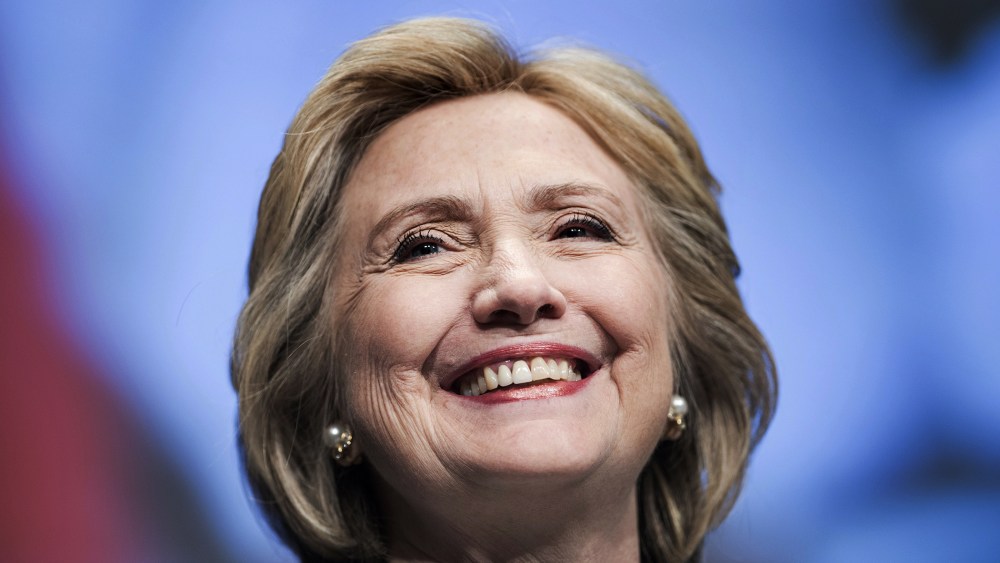 Former Secretary of State Hillary Clinton smiles before speaking at the World Bank May 14, 2014 in Washington, D.C.