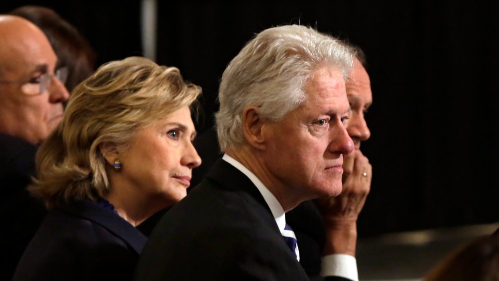 Bill and Hillary Clinton listen to ceremonies during the National September 11 Memorial Museum dedication ceremony on May 15, 2014 in New York City.